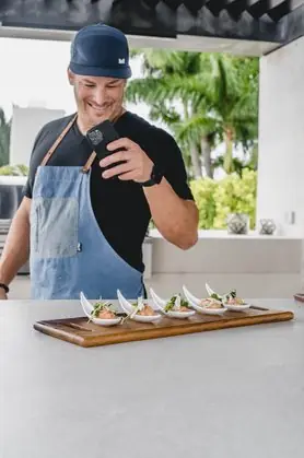 Chef Paul photographing canapés on silver spoons