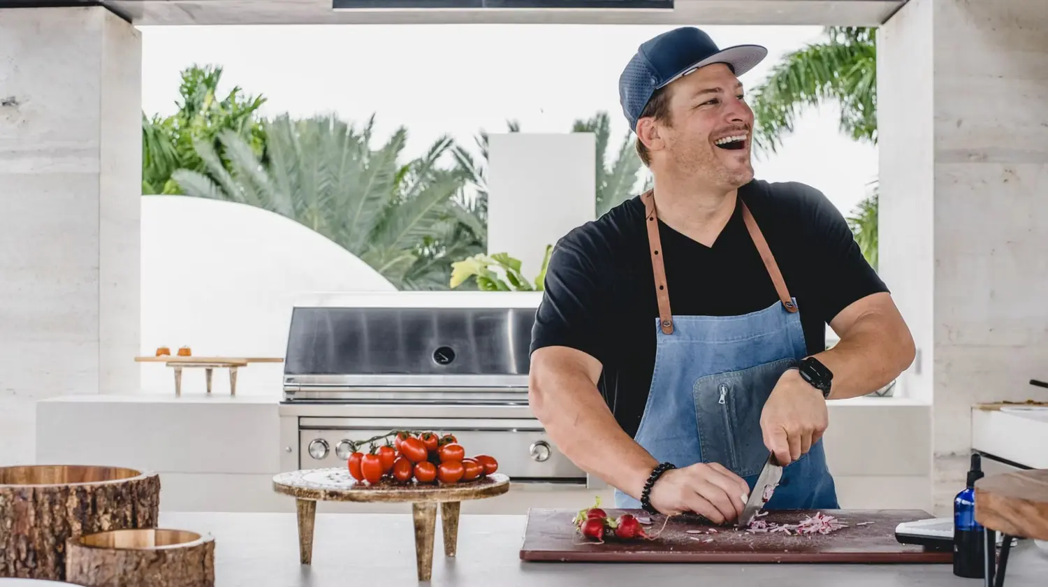 Chef Paul Aceto grilling at an outdoor kitchen